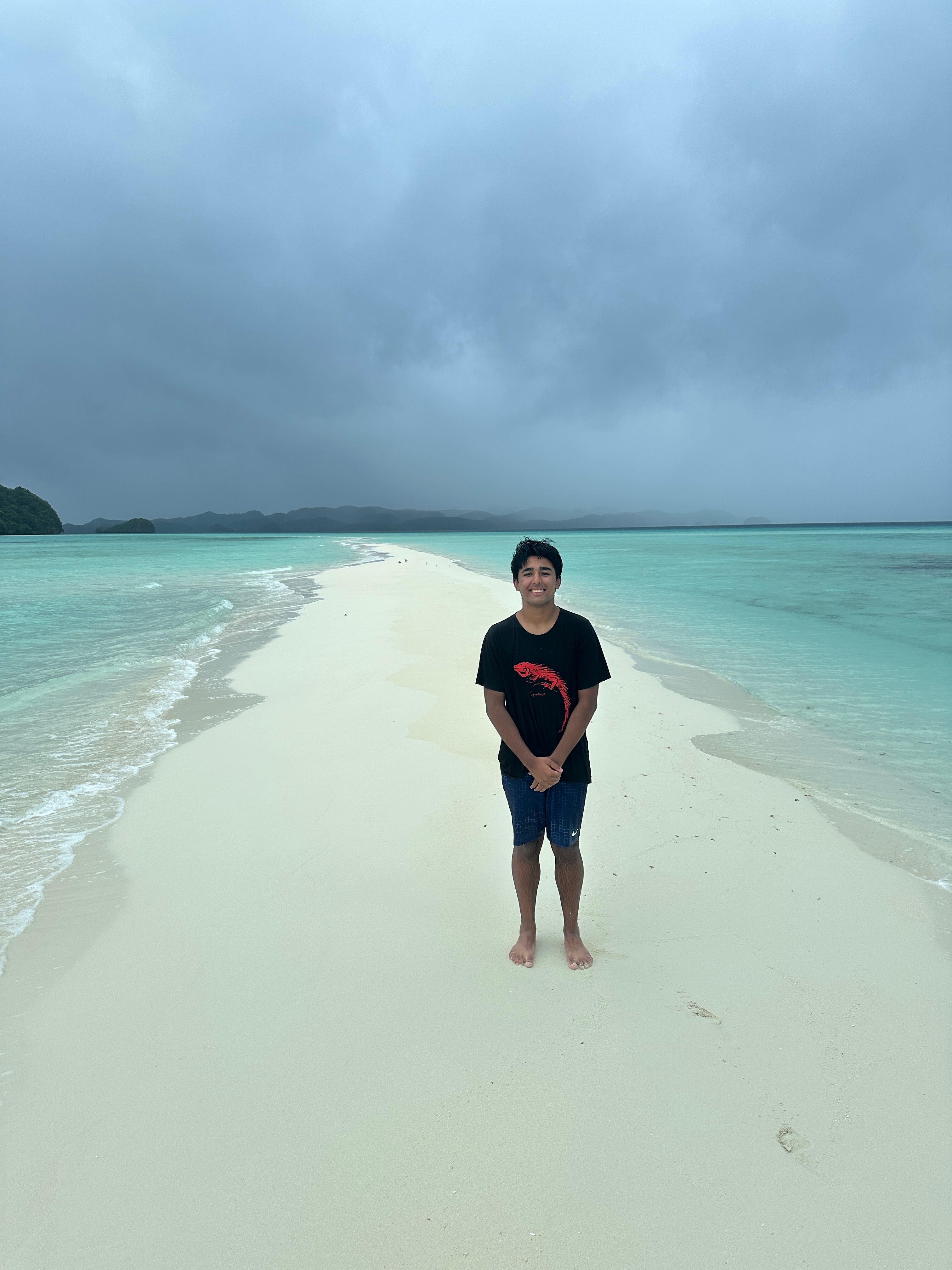 Arjun Malaviya stands on a sandbank in Papua New Guinea. He told NPR that he